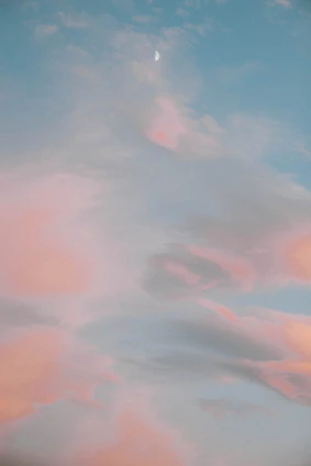 A warm, ethereal studio space with soft watercolor textures and delicate symbols of moon and stars.