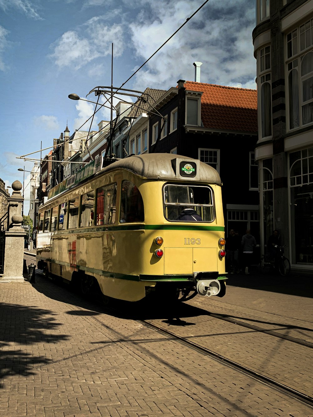 yellow tram on the road