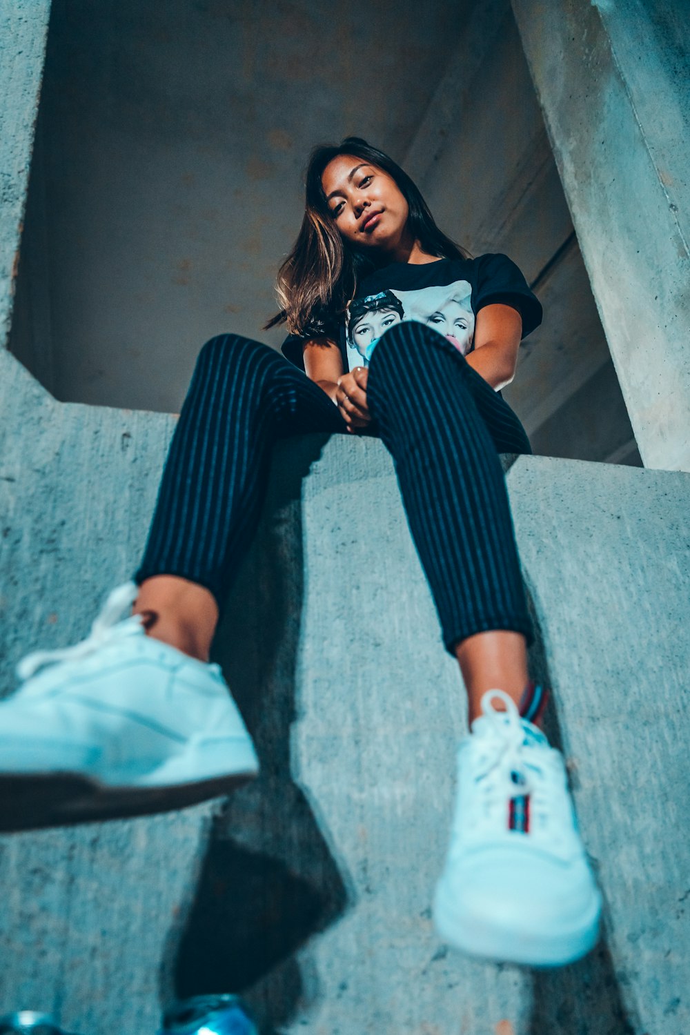 sitting woman wearing black and white crew-neck t-shirt