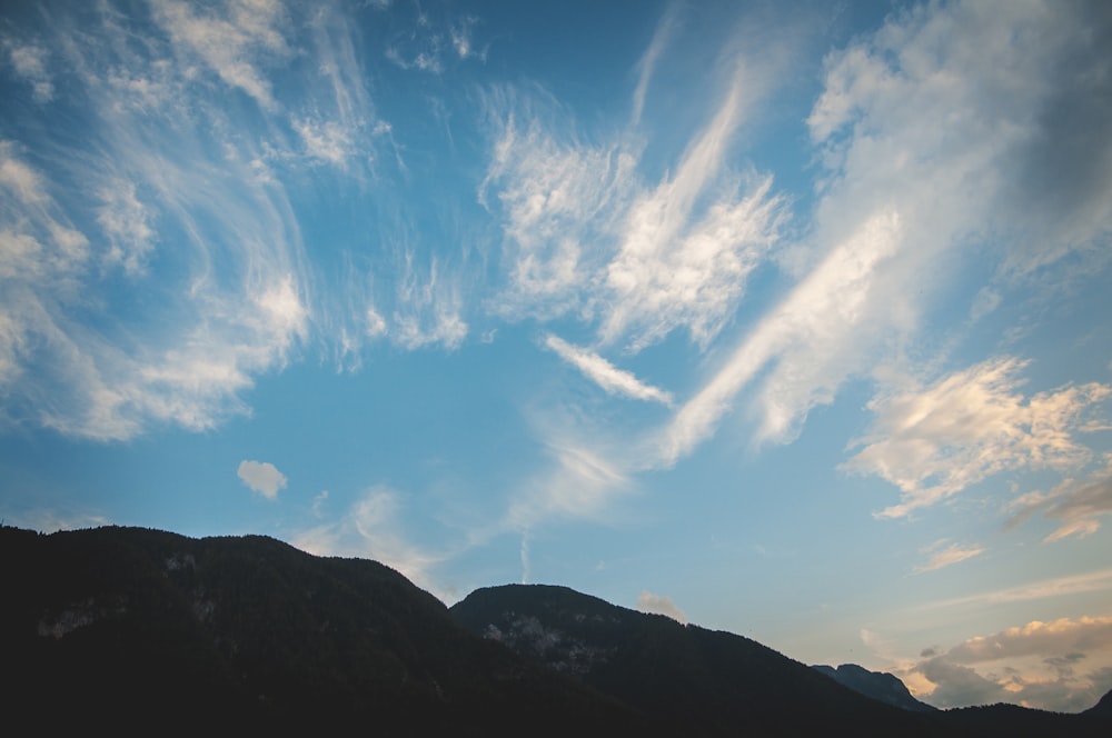 landscape photography of black and gray mountain under white cirrus clouds