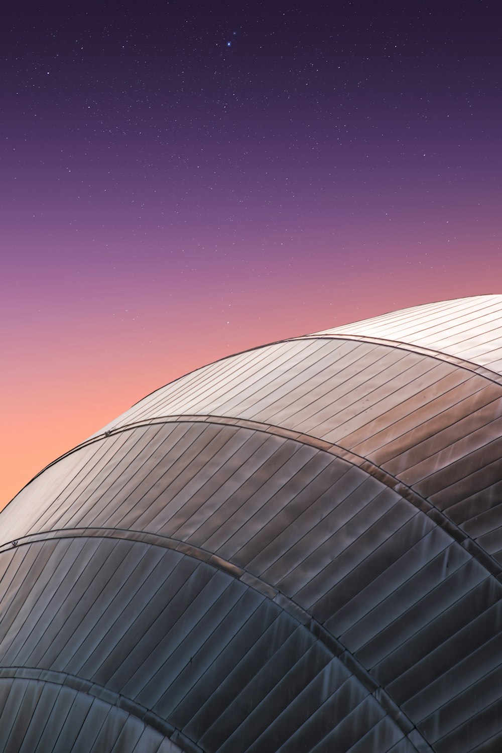 a close up of a building with a sky in the background