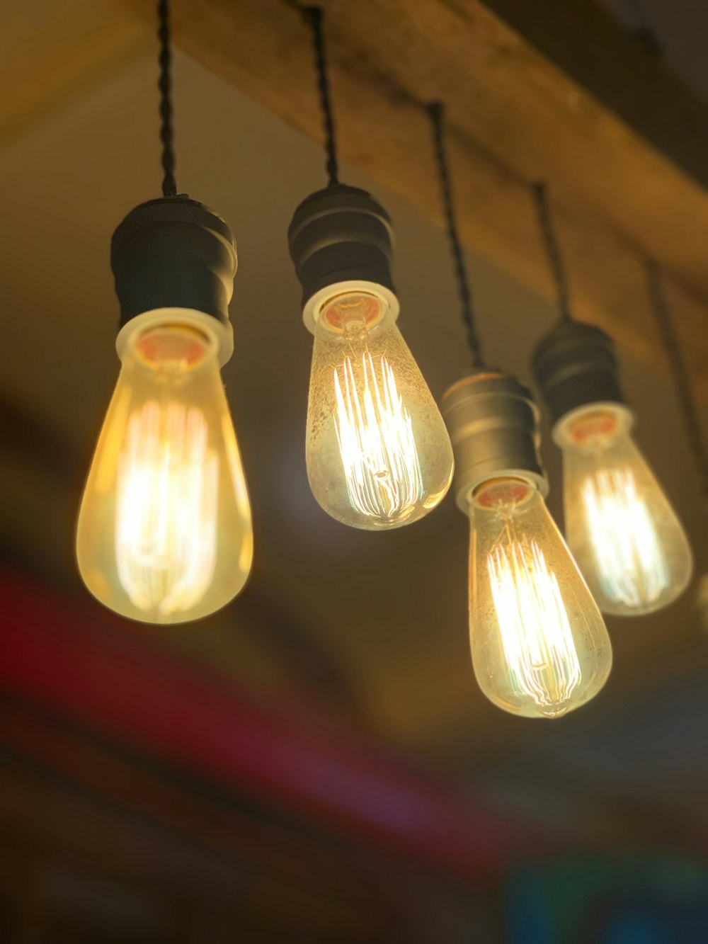 four yellow-and-black Edison light bulbs turned-on