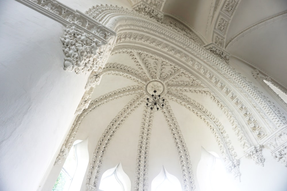 the ceiling of a large building with many windows