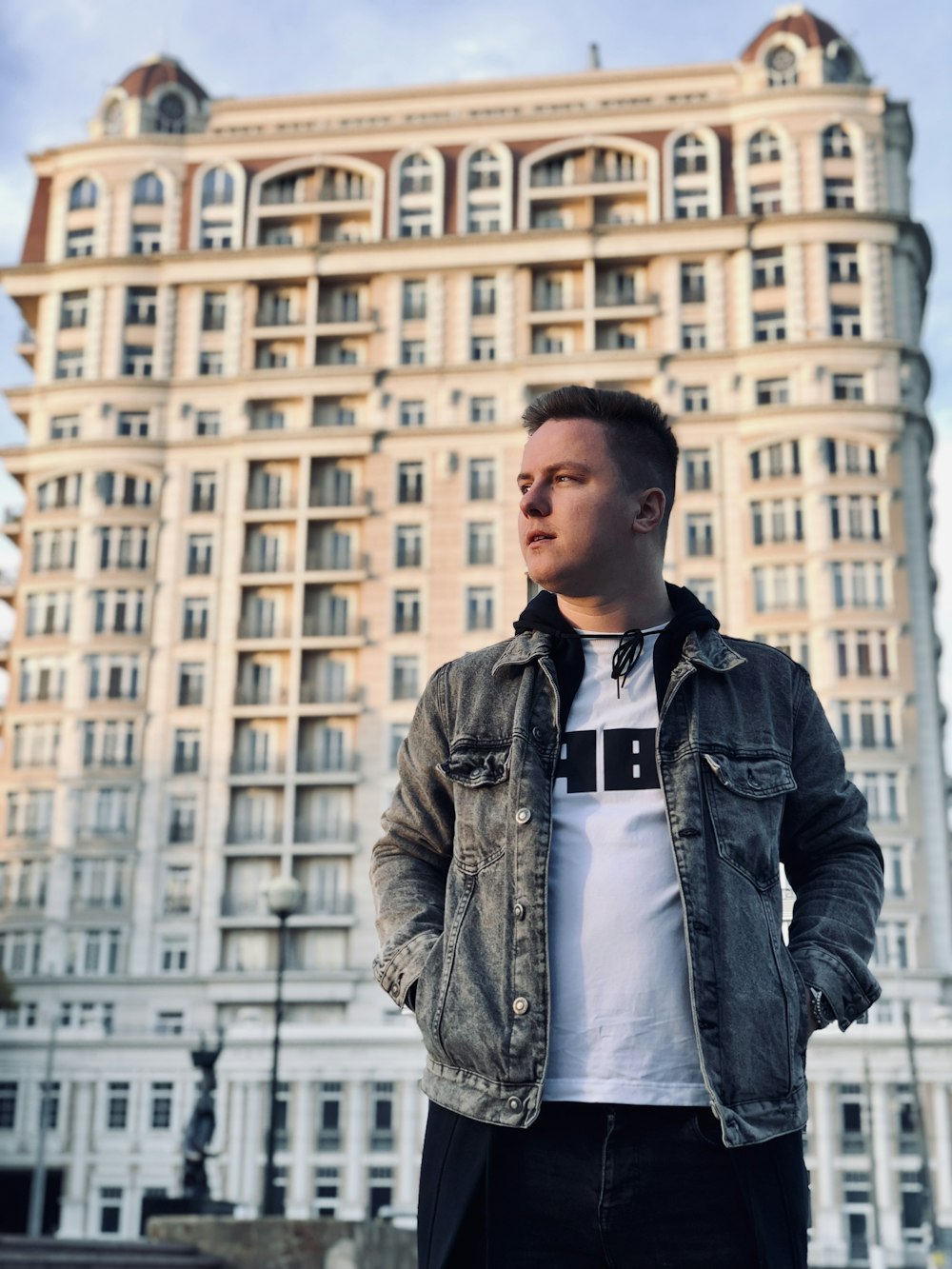 man stands near building