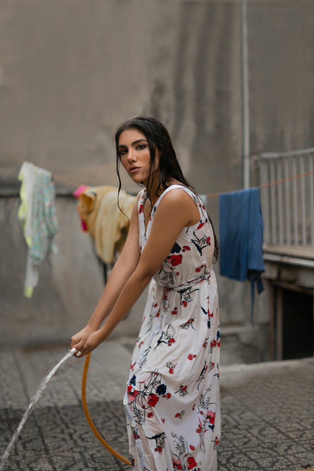 woman holding orange water hose