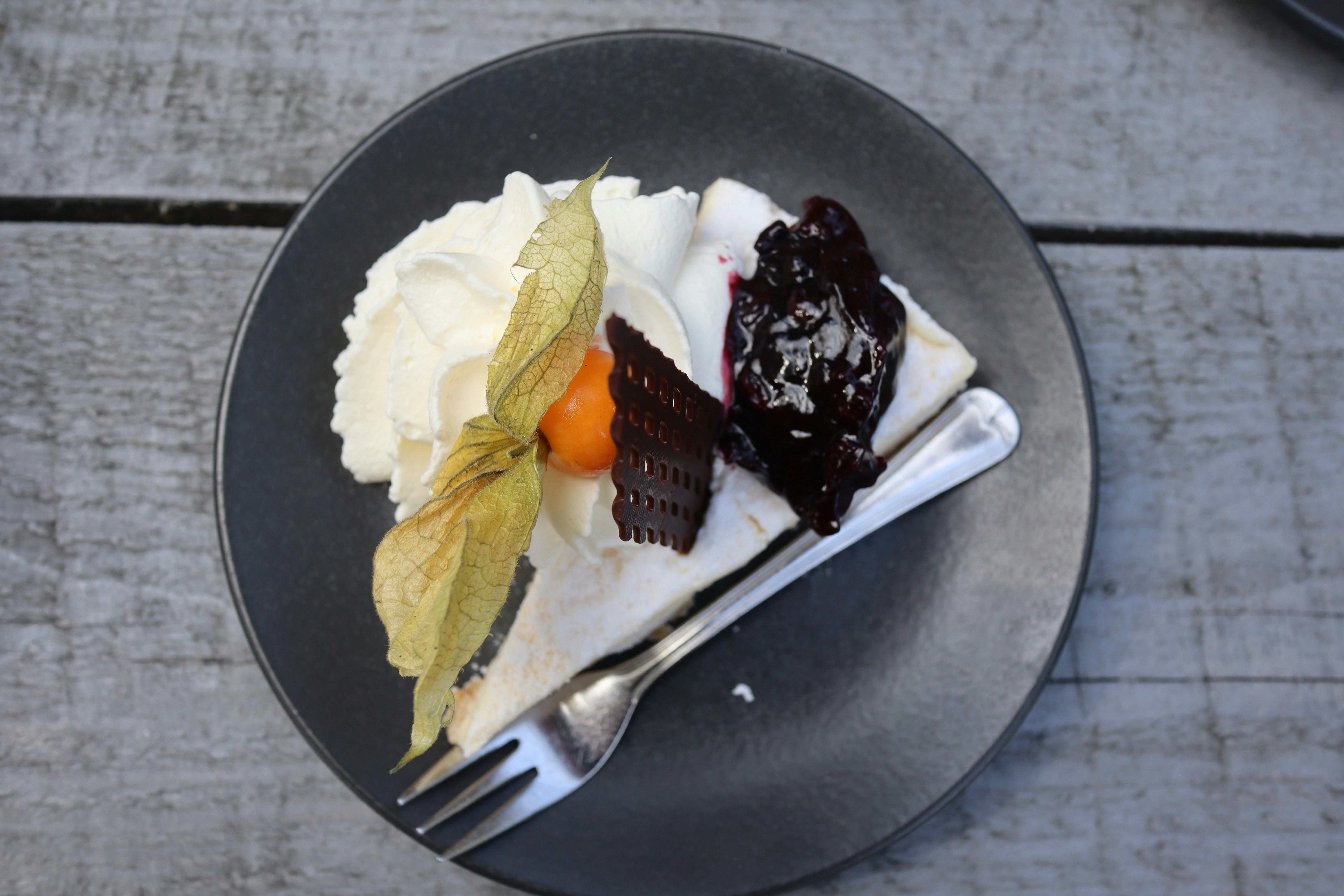 Cheesecake slice with whipped cream and berries