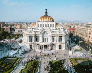 aerial photo of people walking near white concrete dome building during daytime