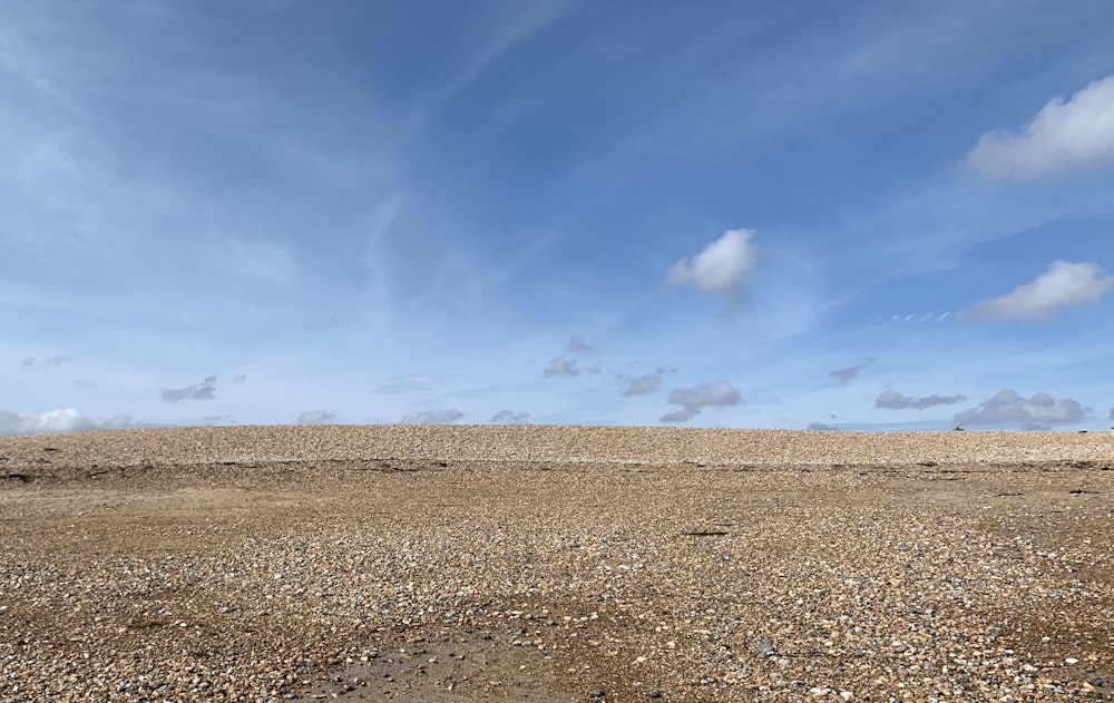 a person flying a kite on a sandy beach