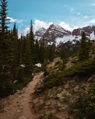 Hiking trails weaving through towering Himalayan peaks under a clear blue sky.