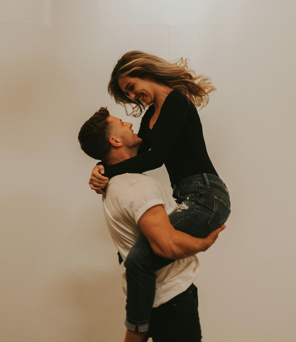 man carries woman