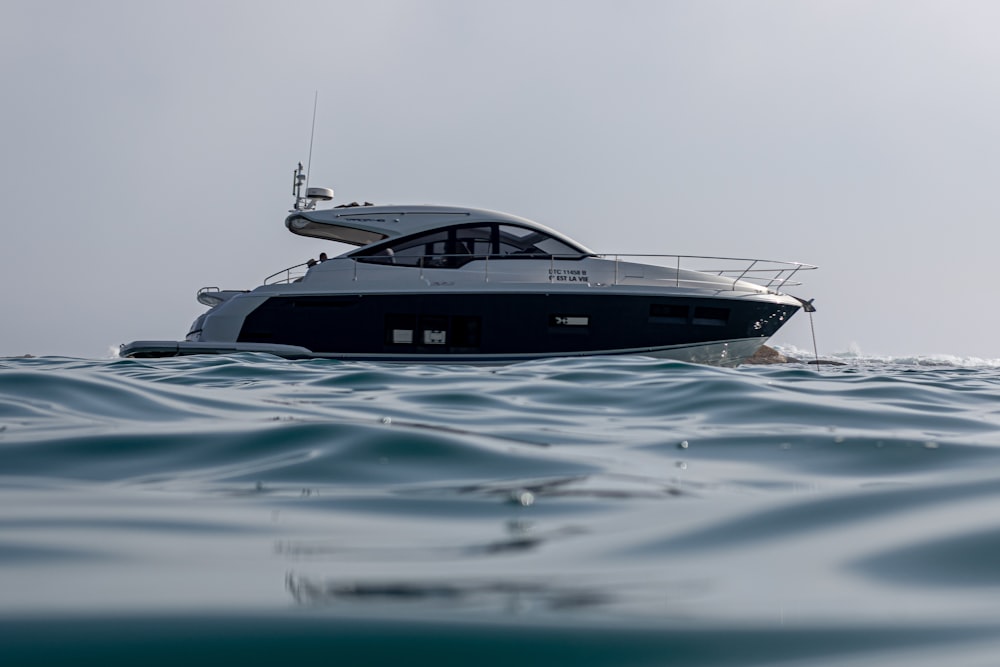 white and black boat on sea during daytime