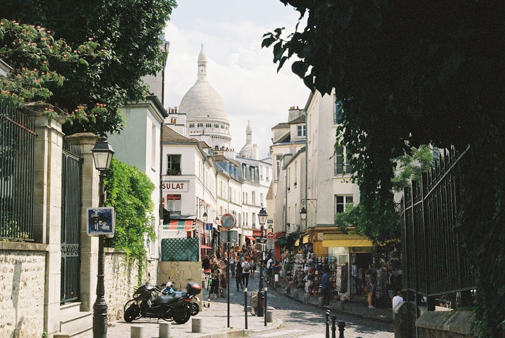 people walking in between buildings during daytime