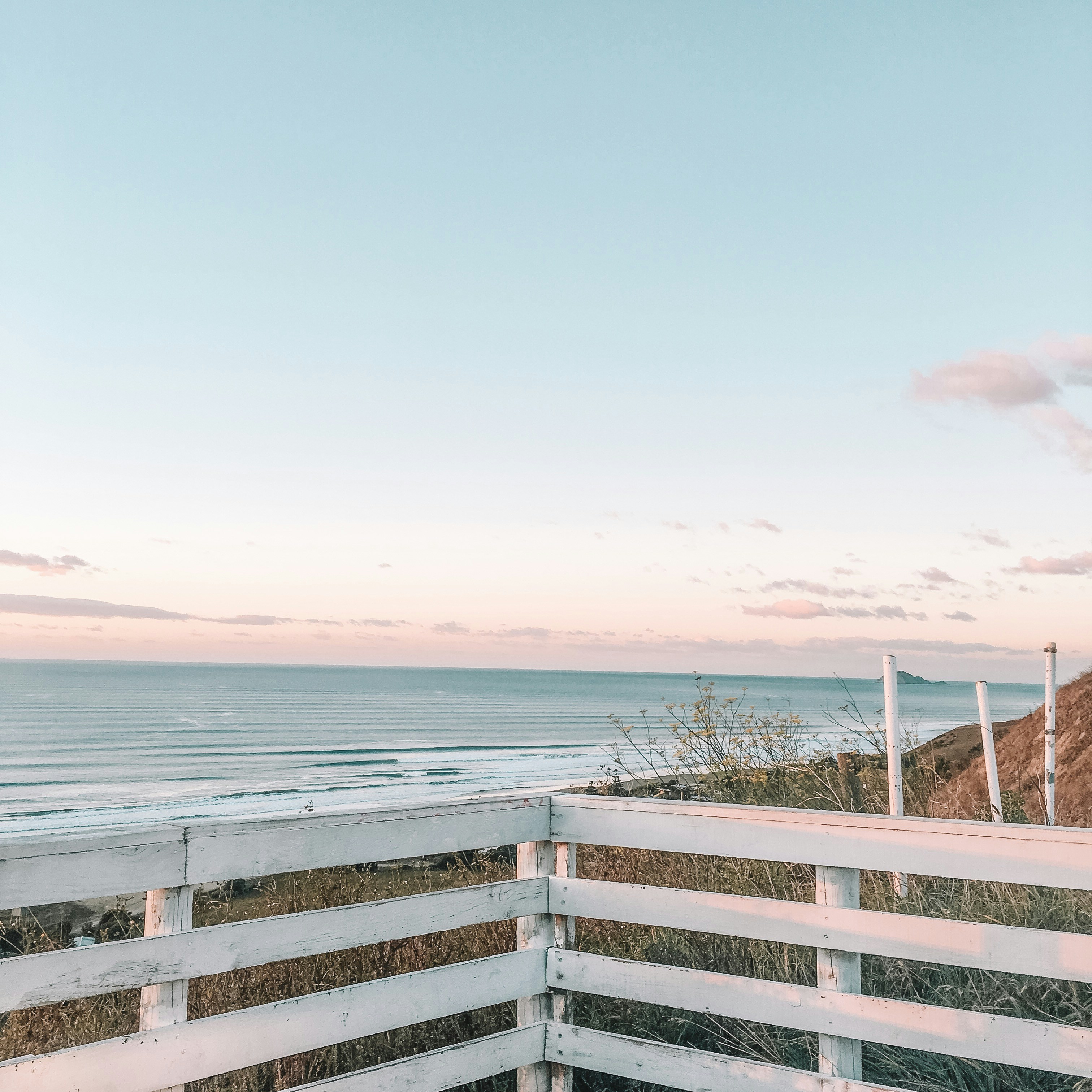 a view of the ocean from the top of a hill