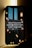 A smartphone leaning against a wall displays a message about conserving energy by turning off unused power points and lights. The screen background features hanging light bulbs, some lit and others dim, casting a warm glow against a dark and possibly urban skyline.