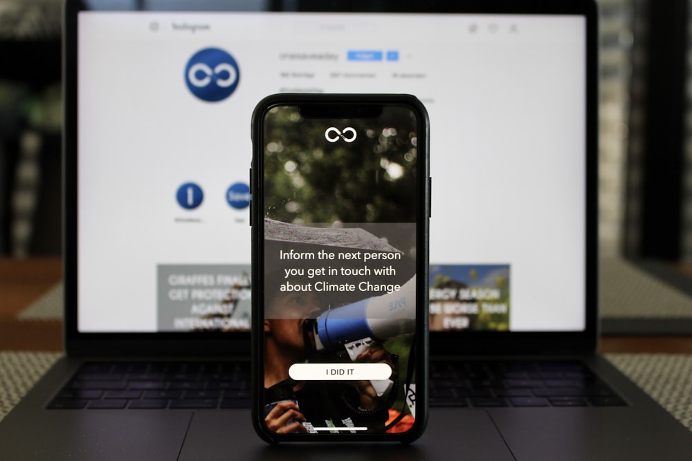 black smartphone on laptop