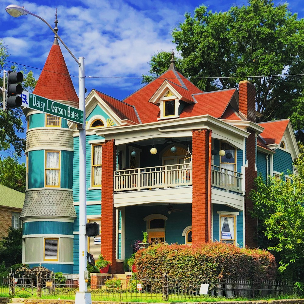 house near trees and traffic light during day