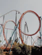 people riding roller coaster during day