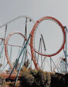 people riding roller coaster during day