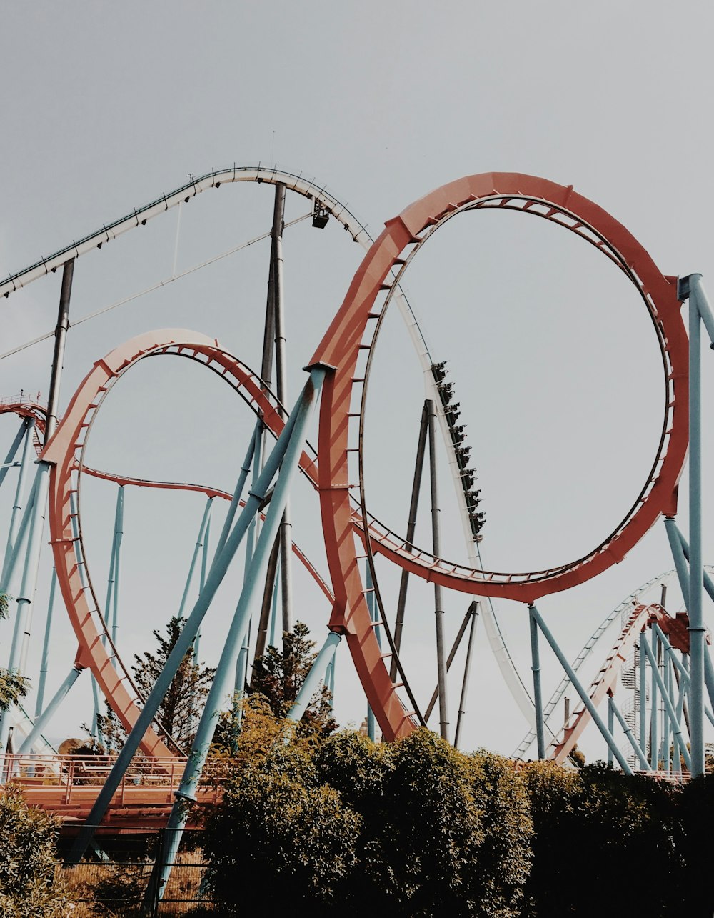 people riding roller coaster during day