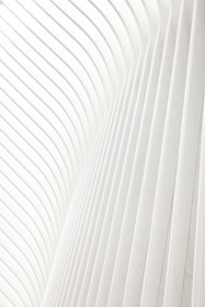 a man riding a skateboard on top of a white wall