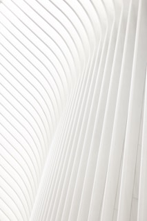 a man riding a skateboard on top of a white wall