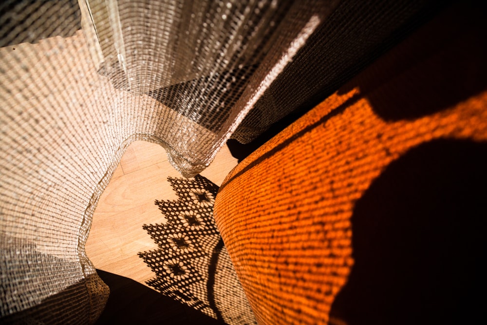 a close up of a fan with a person's shadow on it