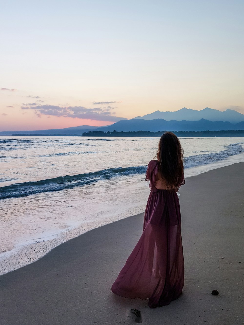 woman standing on seashore during day