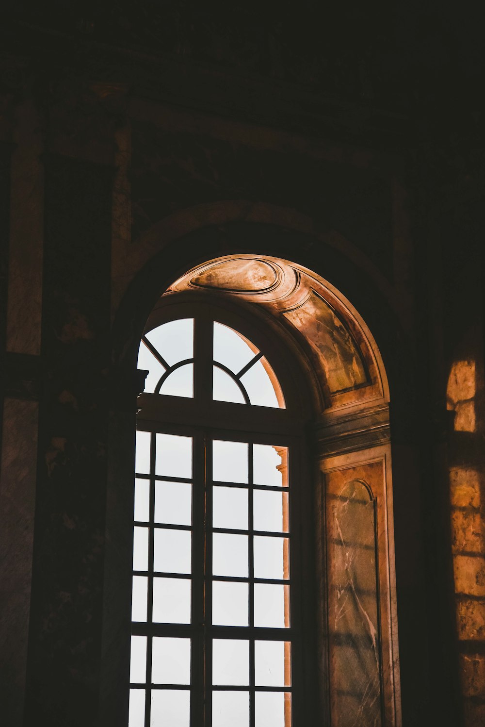 a window in a building with a statue in front of it