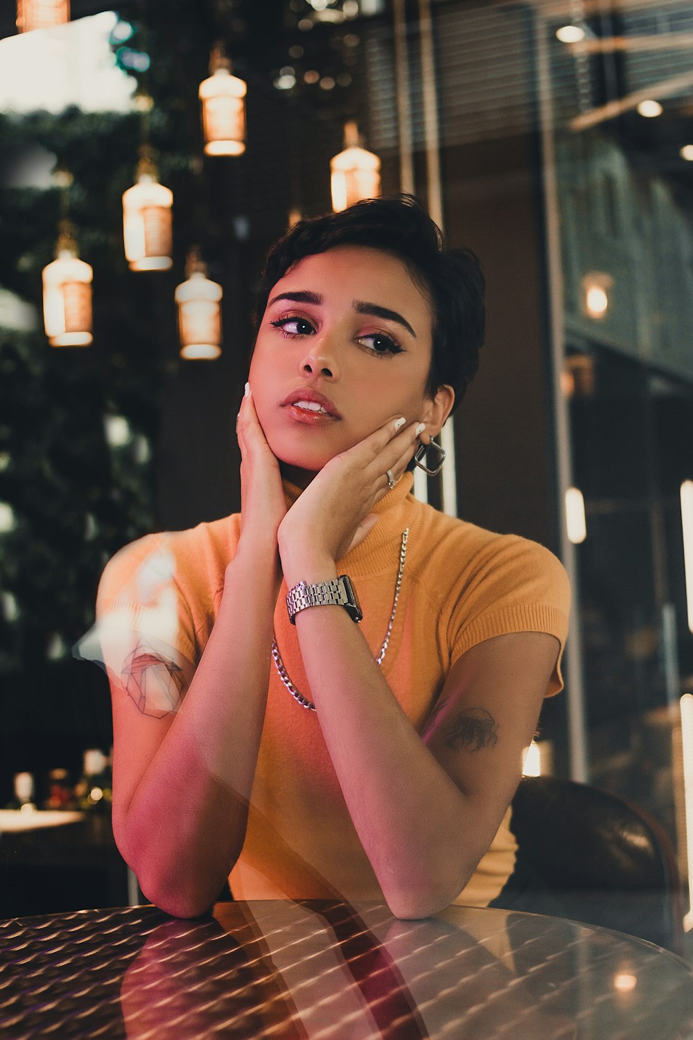 women wearing yellow shirt sitting beside table