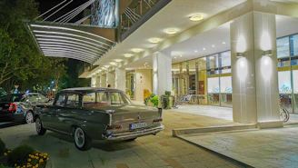 gray sedan parked beside lighted building