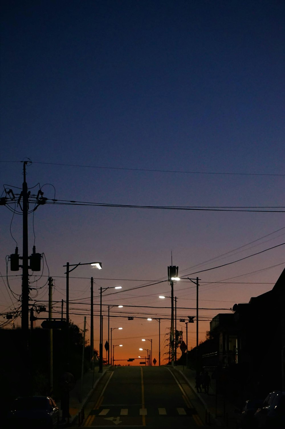 a street at night with street lights and cars