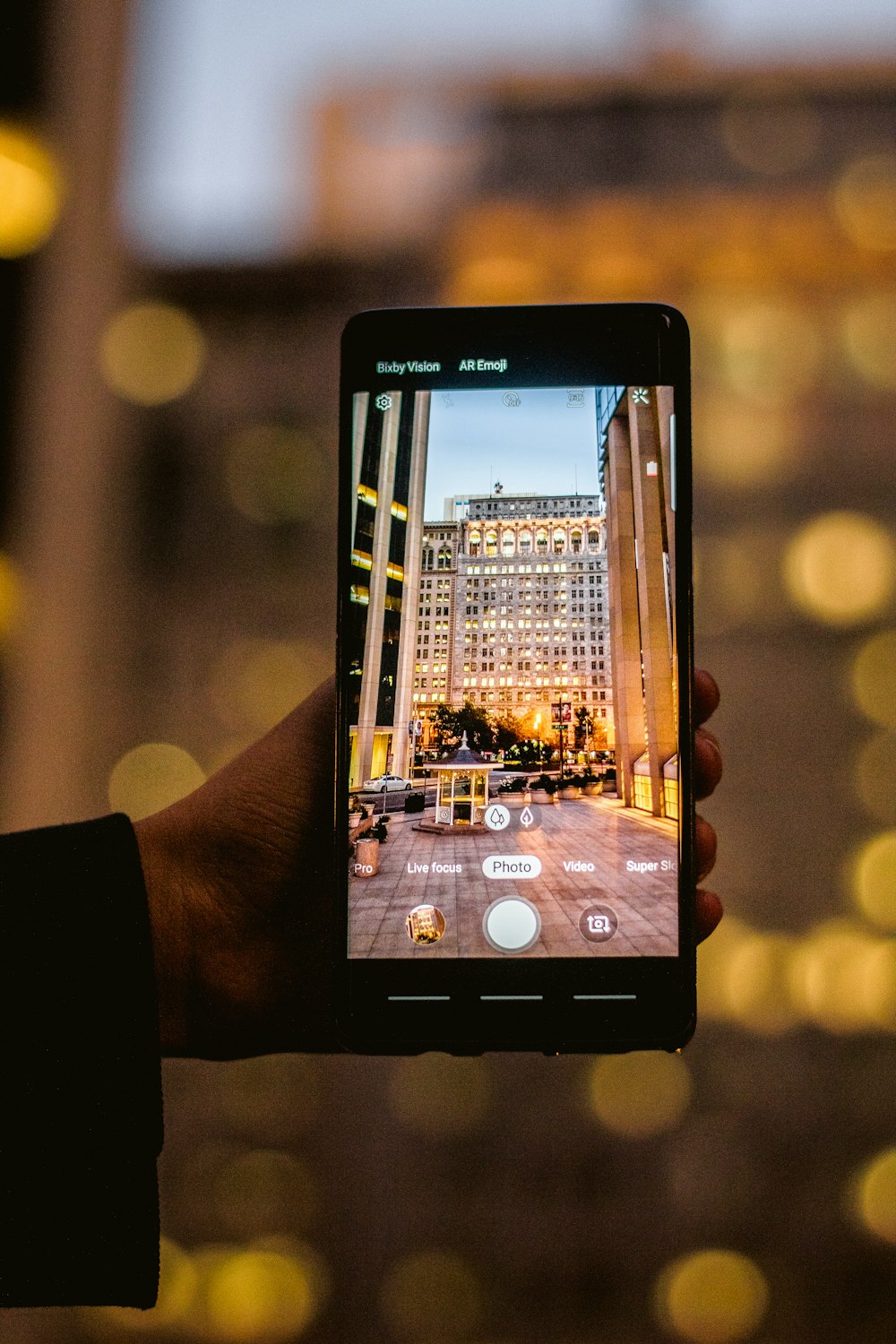 a person taking a picture of a city at night