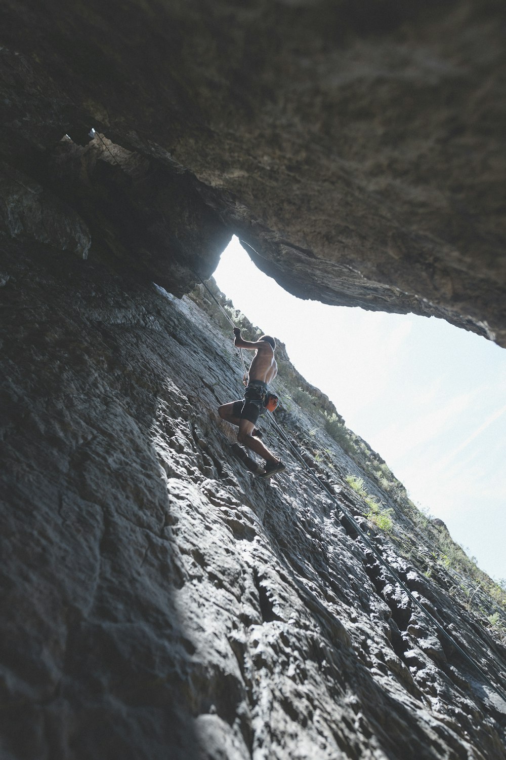 a man climbing up the side of a cliff