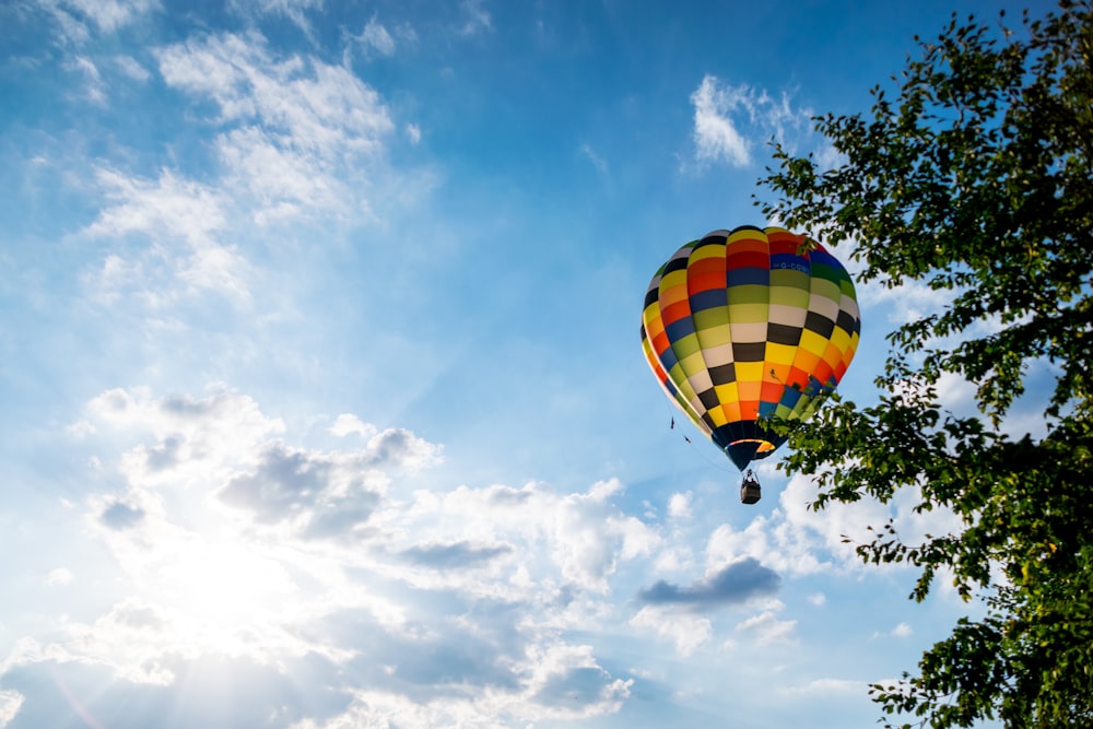 a colorful hot air balloon flying through a blue sky