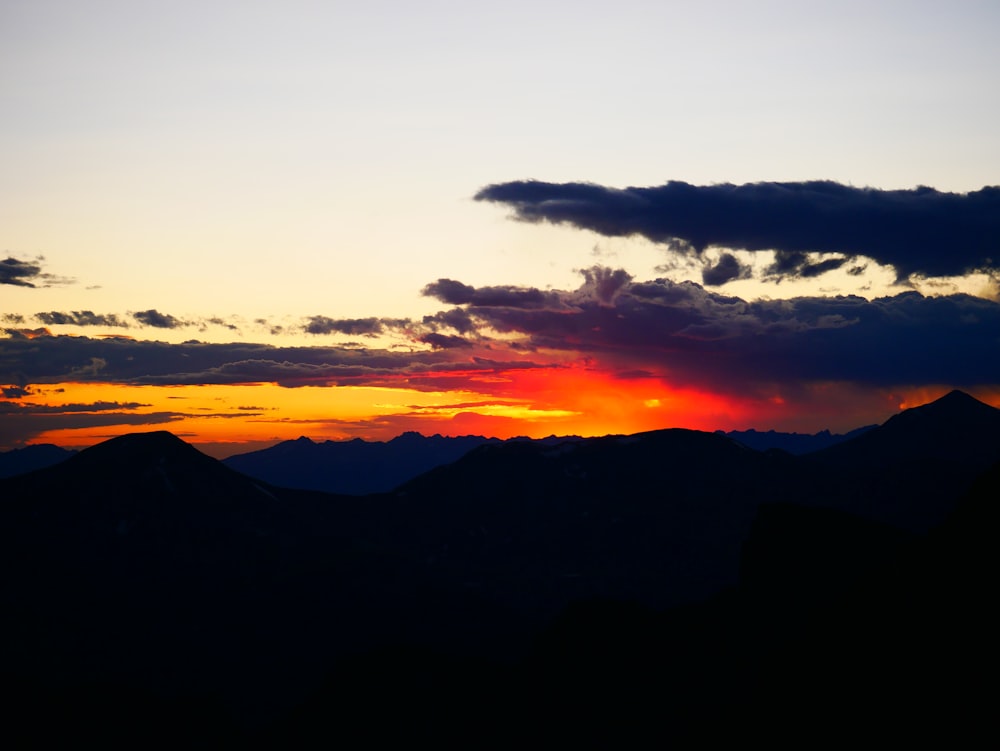 silhouette photo of clouds during golden hour