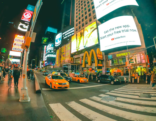 Times Square bustling with colorful billboards and crowds at night