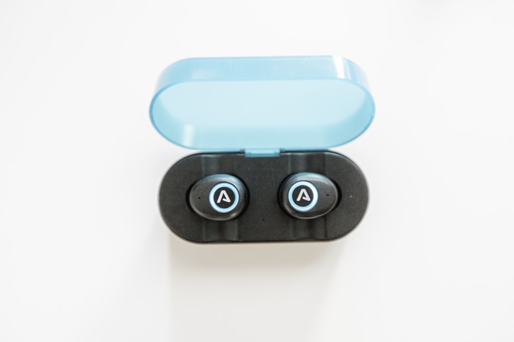 black-and-blue Bluetooth earphones with black and blue case