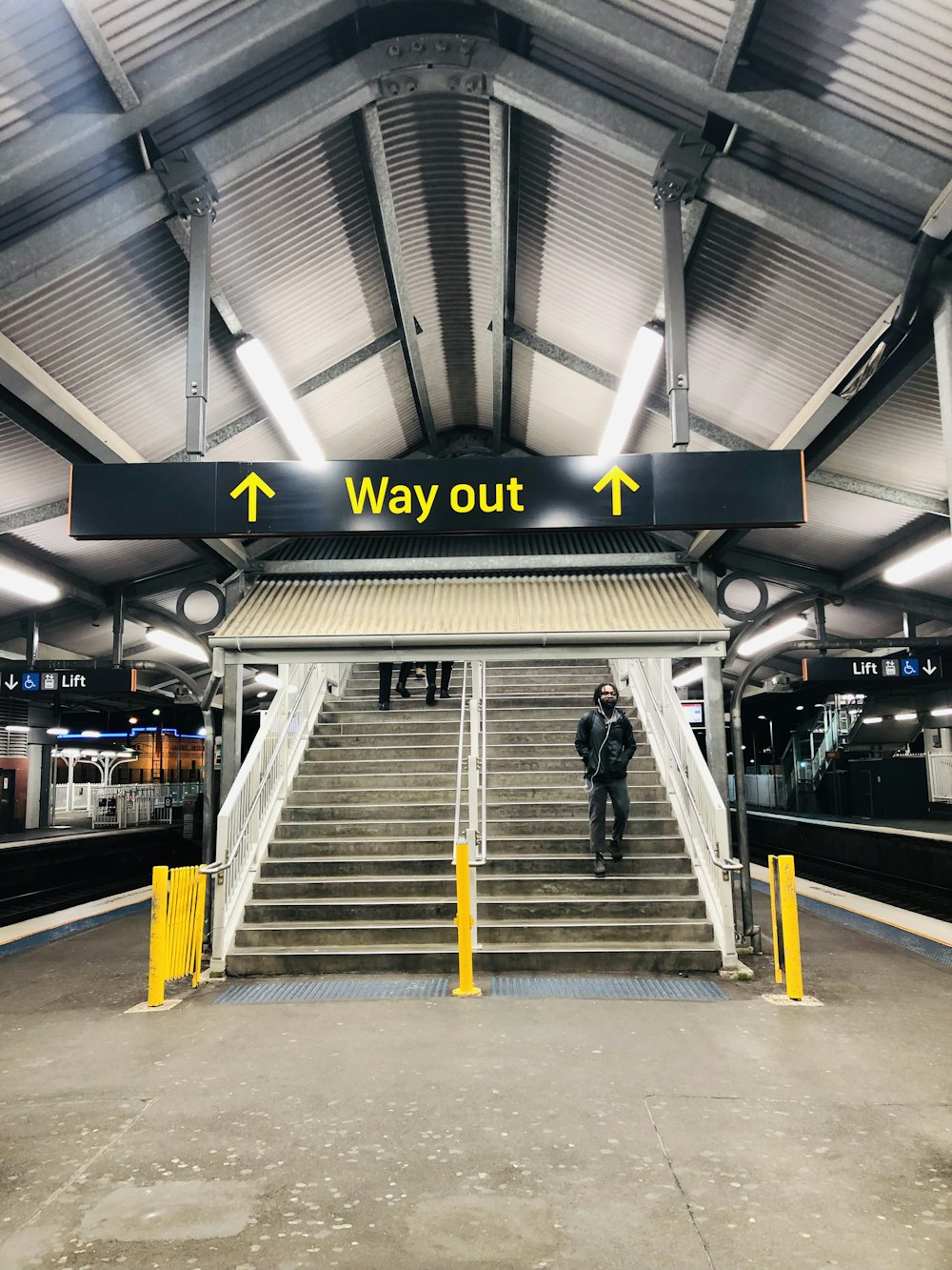 yellow and black Way Out signage