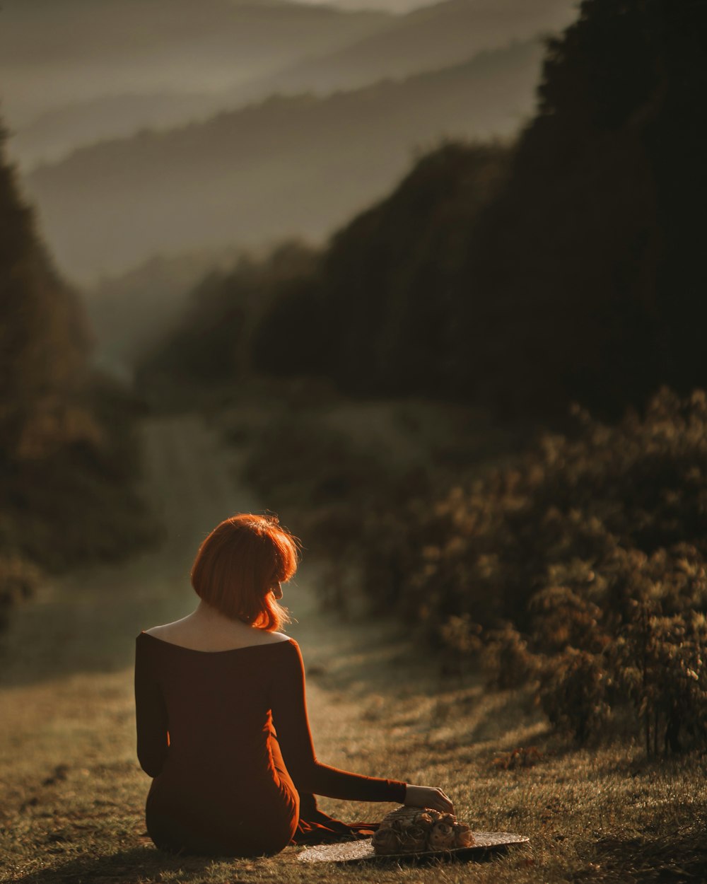 woman sits on pathway