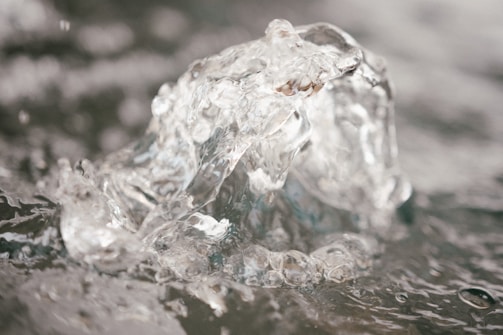 Close-up of crystal-clear water flowing from an Enagic Kangen machine, highlighting purity and freshness.