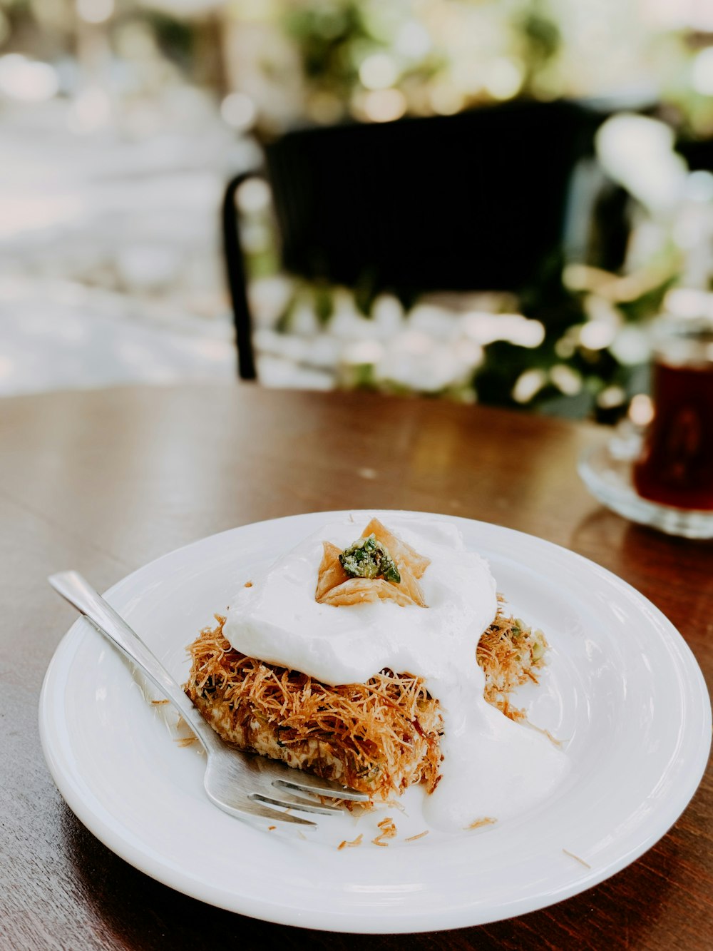 a white plate topped with food on top of a wooden table