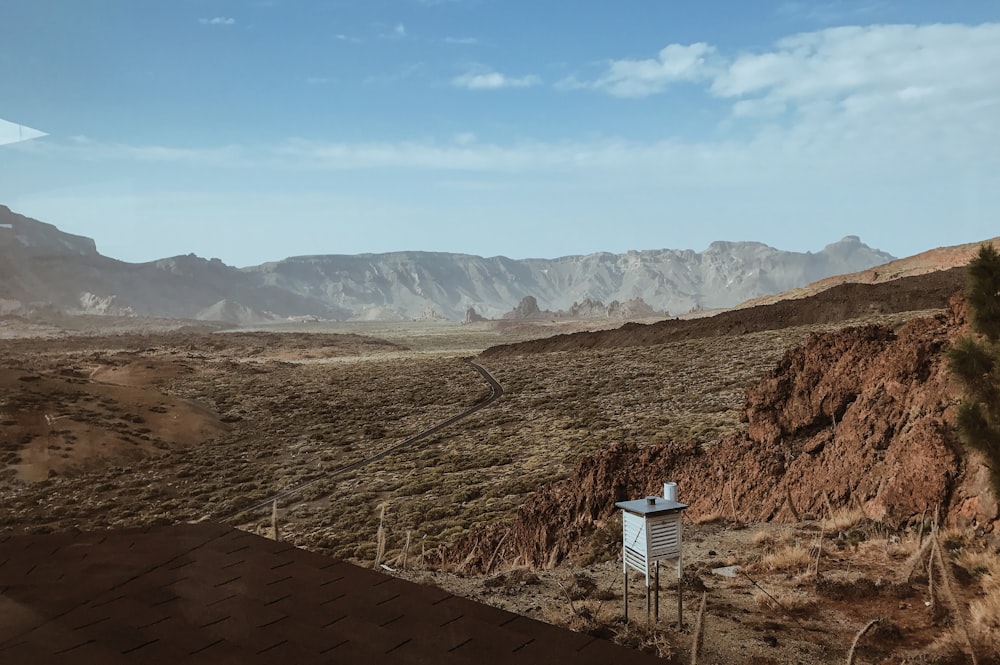 a view of a desert with mountains in the background