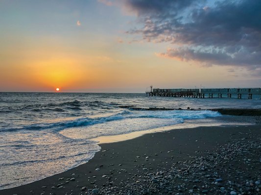 Sunset over the sea and the pier — Sochi, Russia