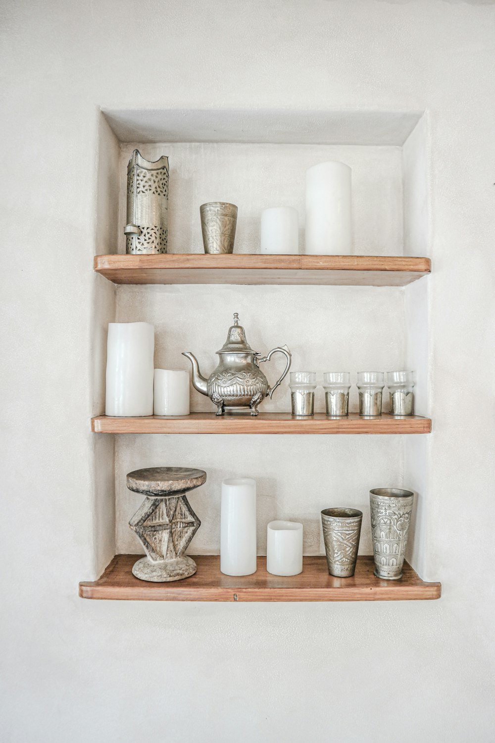 a couple of shelves filled with cups and vases