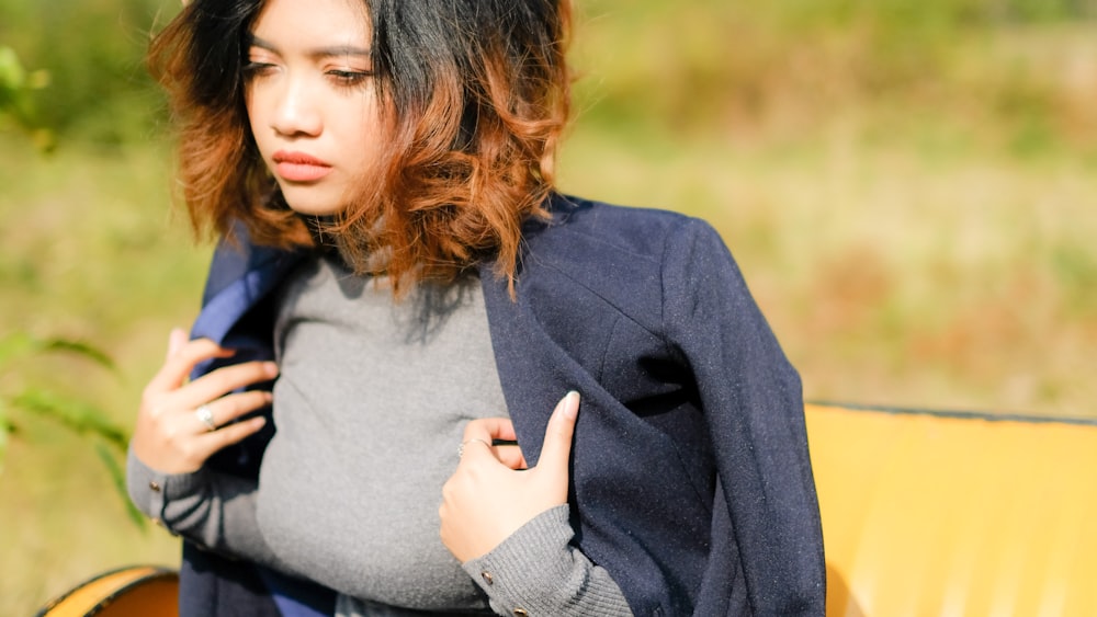 woman in gray turtleneck top and black blazer