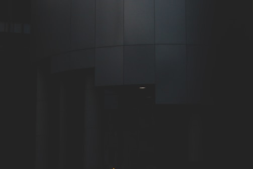 Minimalist Andean-inspired architectural blueprint with gold accents on dark stone.