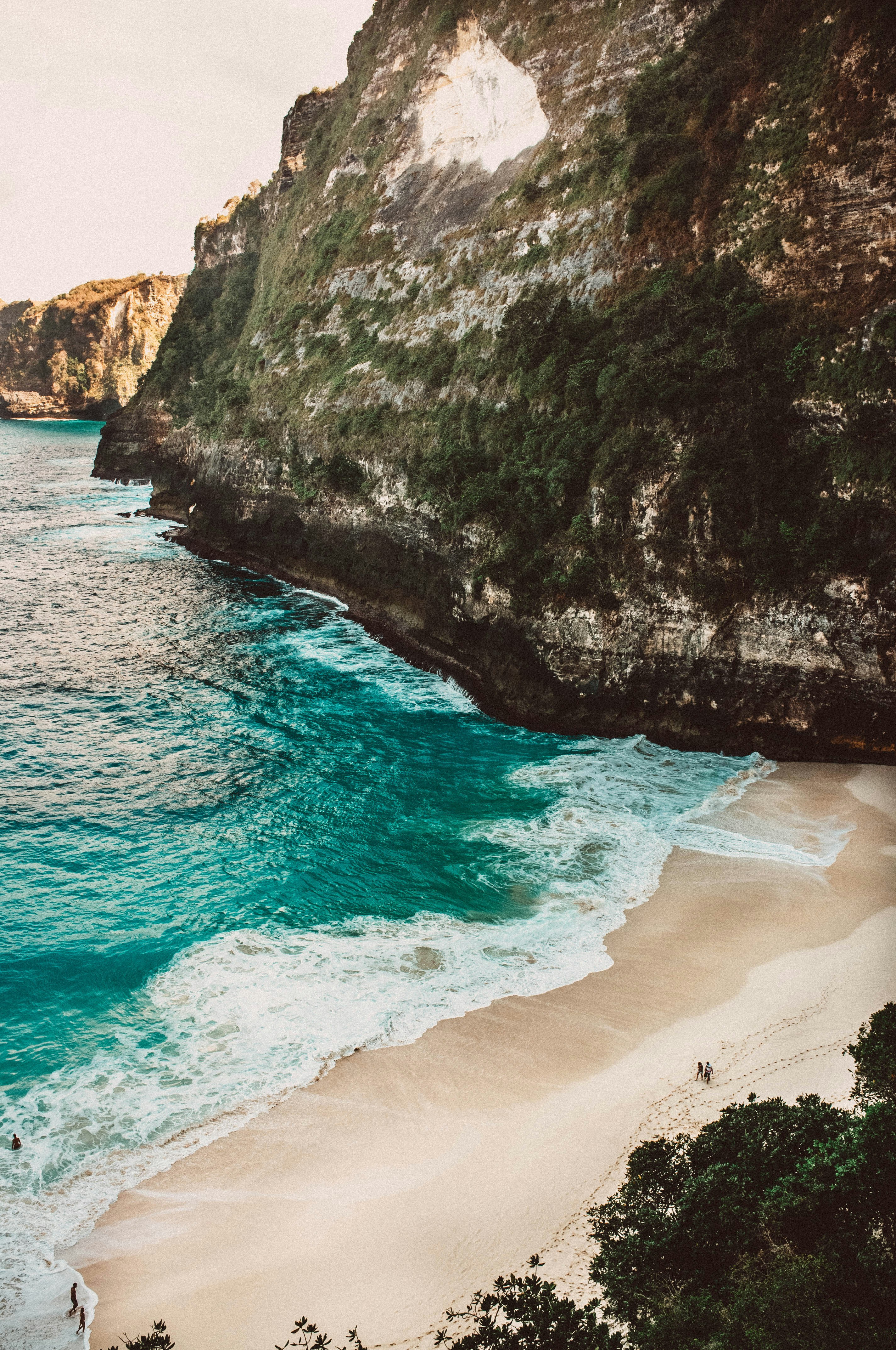 photography of seashore and mountain cliff during daytime