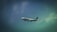 A commercial airplane is flying in the sky, featuring the logo and branding of an airline company on its fuselage. The aircraft is captured against a backdrop of a gradient sky transitioning from a dark to light blue hue with clouds visible.