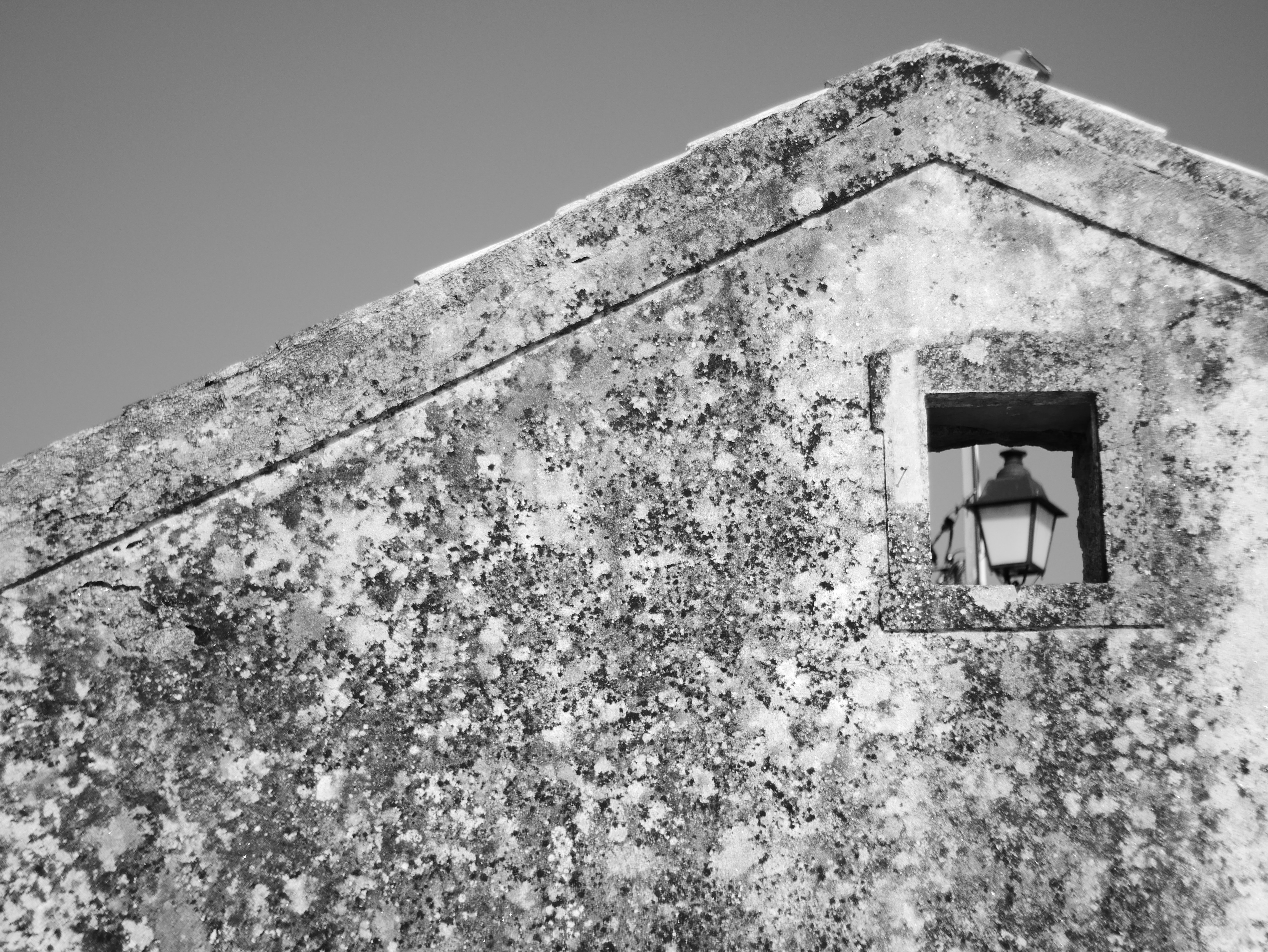 a clock tower with a window in the middle of it