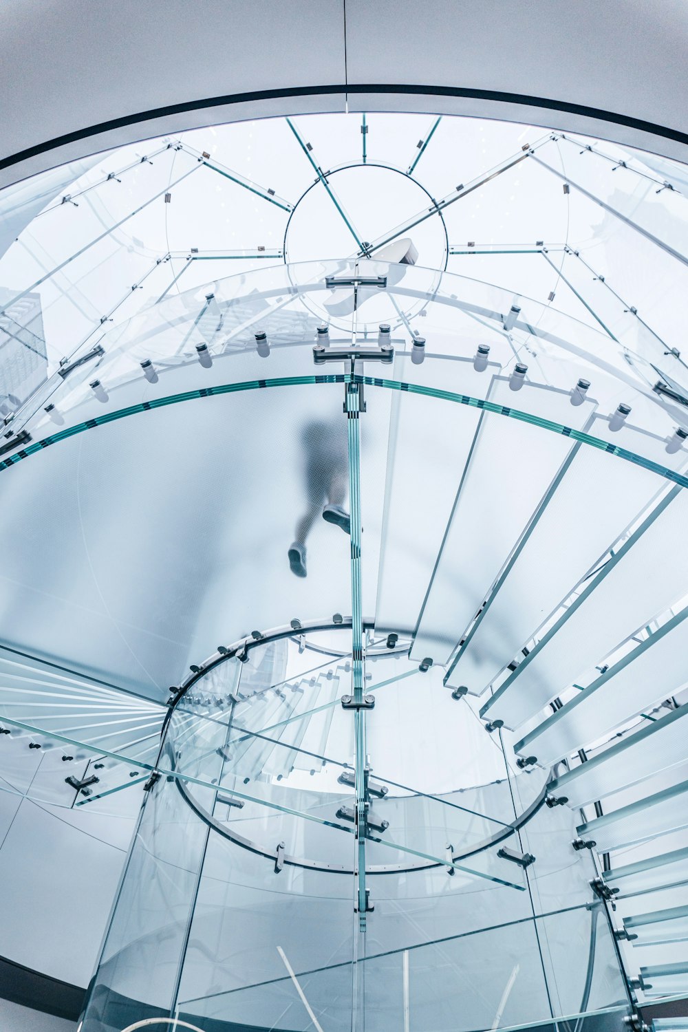 person standing on clear-glass staircase